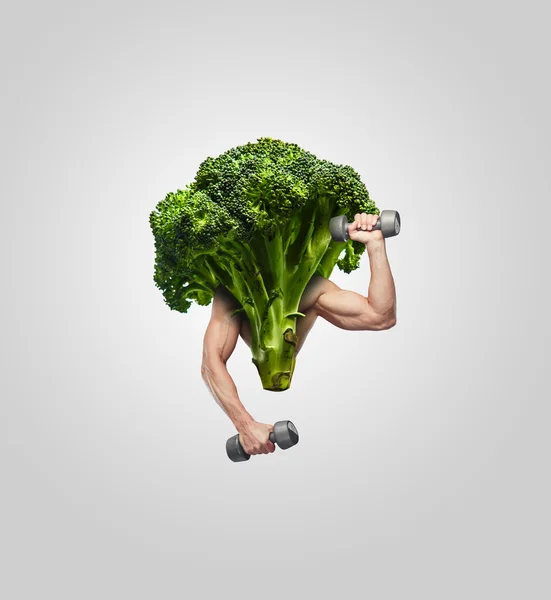 Broccoli with muscular man's hands. — Stock Photo, Image
