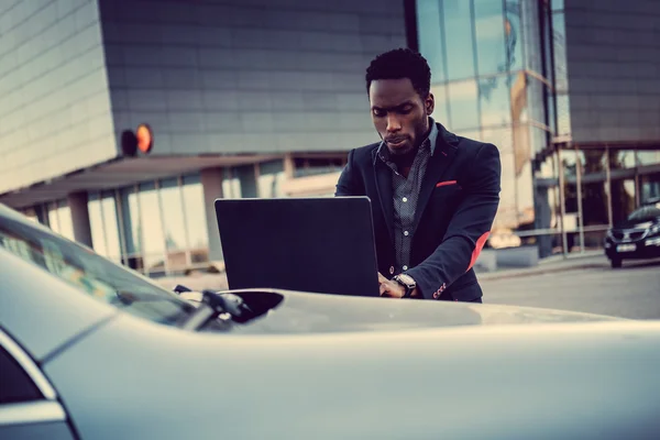 Stylish african male using laptop — Stock Photo, Image