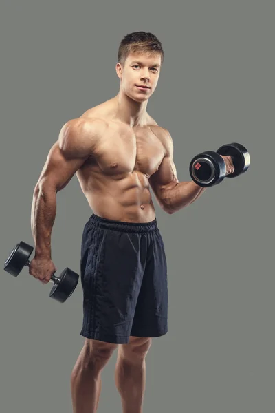 Male doing biceps exercises with dumbbells — Stock Photo, Image