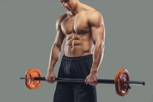 Um homem segurando barbell — Fotografia de Stock