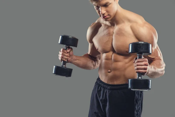 Male doing biceps exercises with dumbbells — Stock Photo, Image