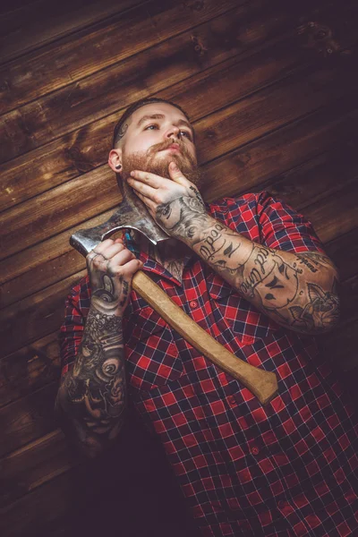 Tätowierter Mann hält Axt in der Hand — Stockfoto