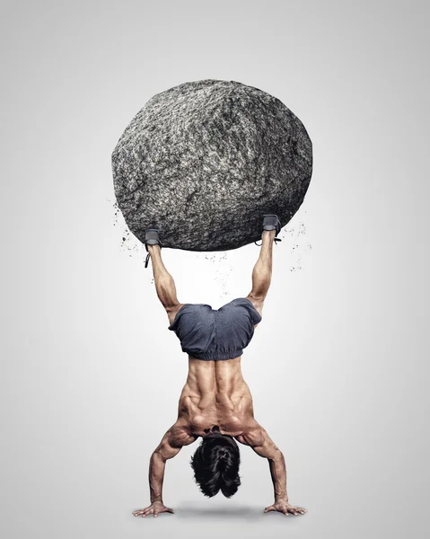 Male upside down with grey stone — Stock Photo, Image