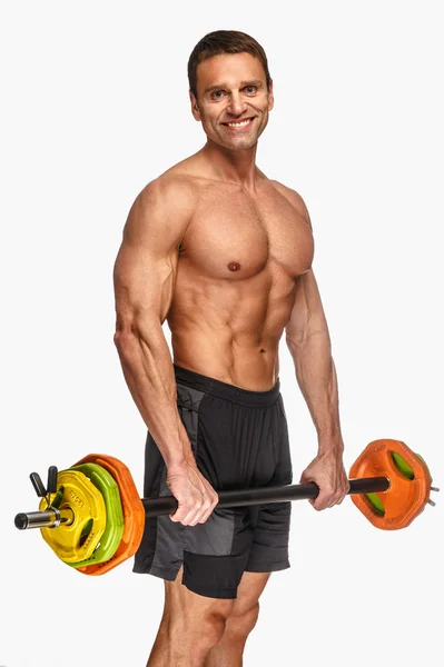 Shirtless poseren met kleurrijke barbell — Stockfoto