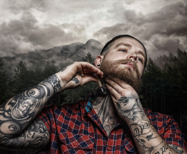 Shaving brutal tattooed male