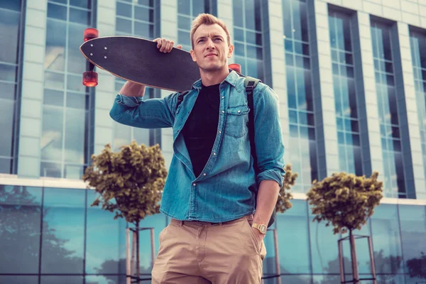 Casual masculino urbano segurando longboard — Fotografia de Stock