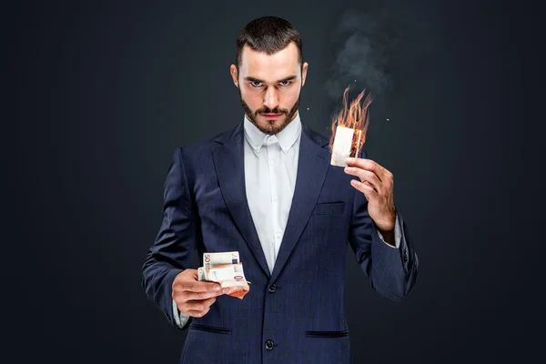 Male holding burning bank card — Stock Photo, Image