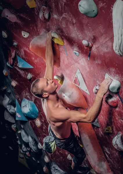 male climbing on an indoor climbing wall