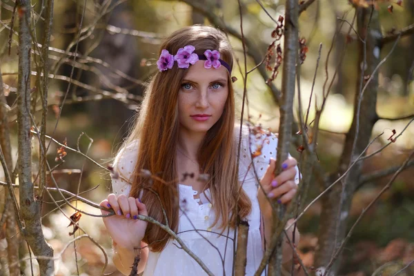 Freckled woman with circlet of flower — Stock Photo, Image