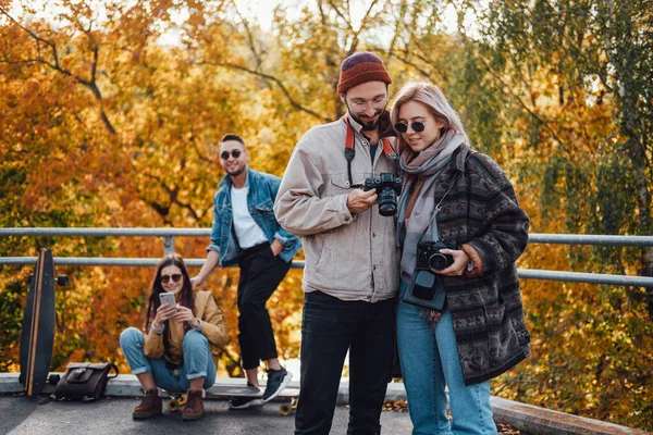 Four friends spending holidays together in autumn park — Stock Photo, Image