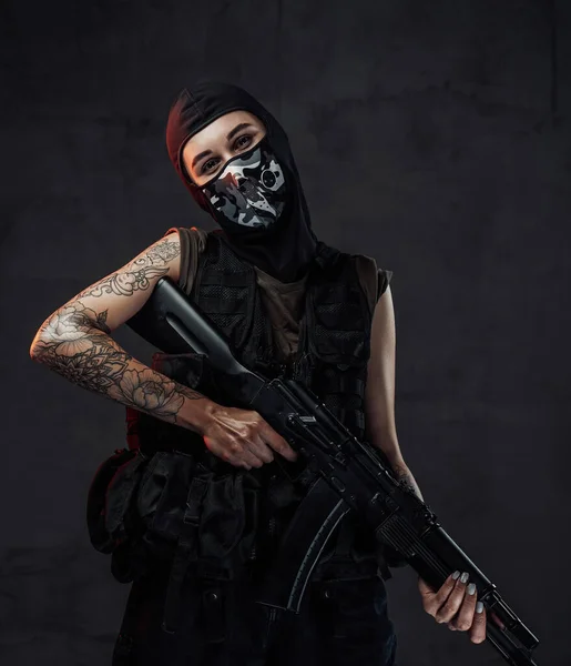 Mujer militar alegre posa en fondo oscuro sosteniendo rifle de asalto —  Fotos de Stock