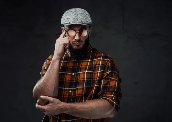 Stylish strong guy with cap and sunglasses poses with crossed arms — Stock Photo, Image