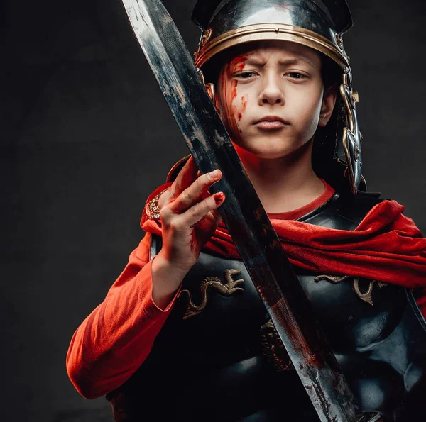 Handsome roman little soldier with bloody arm and sword — Stock Photo, Image