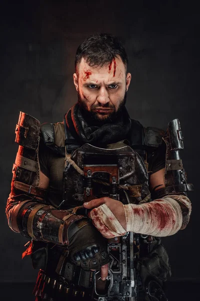 Staring at camera damaged stalker with shotgun in dark background — Stock Photo, Image