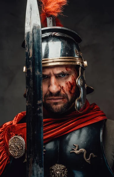 Angry greece warrior in armour holding his sword — Stock Photo, Image