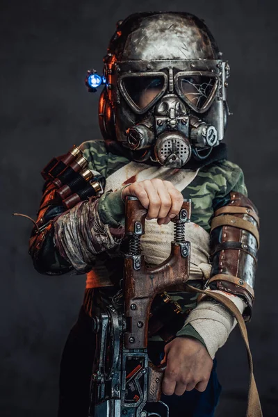 Armed with riffle little boy with gas mask in dark background — Stock Photo, Image