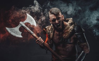 Screaming scandinavian warrior with huge axe in fog clipart