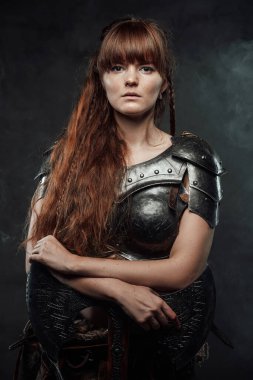 Savaşçı dişi Viking sisli arka planda büyük bir balta taşıyor.