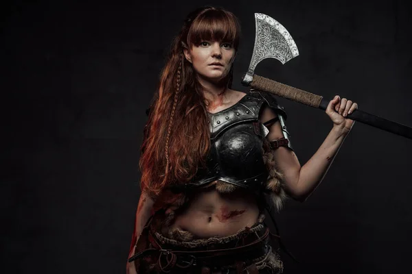 Nordic amazon with axe on her shoulder in dark background — Stock Photo, Image