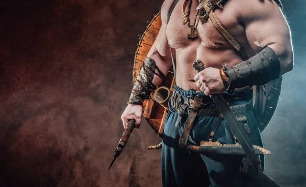 Powerful and muscular viking holding hatchet and knife — Stock Photo, Image