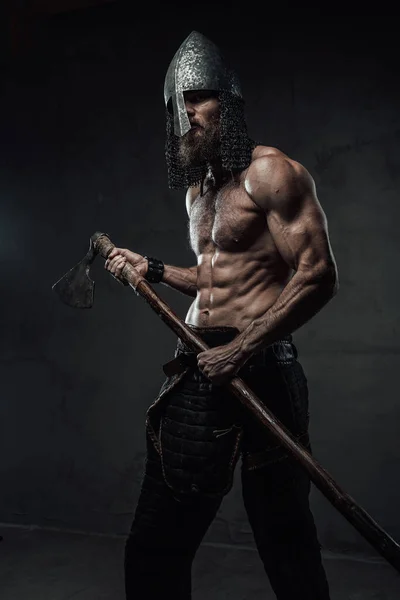 Nord warrior posing with his axe in dark background — Stock Photo, Image
