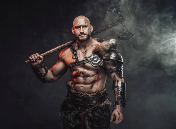 Violent topless viking holding huge axe on his shoulder in smokey background — Stock Photo, Image