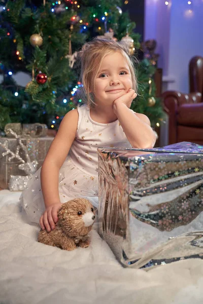 Gelukkig klein meisje met kerst aanwezig in versierde kamer — Stockfoto