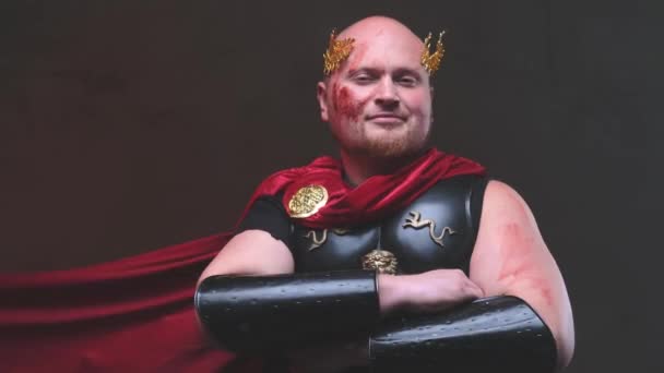 Authoritative bald empire military person posing with crossed arms in dark background — Stock Video