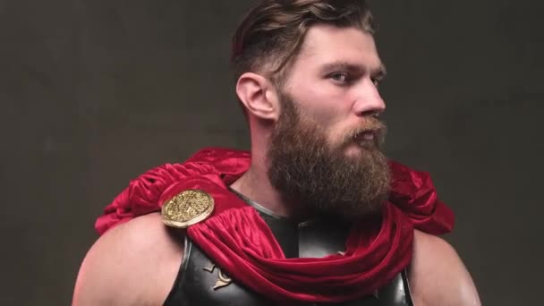 Bearded and armoured gladiator posing in dark background — Stock Video