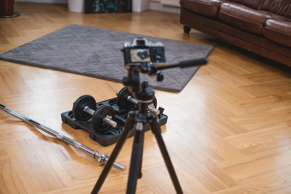 Photocamera πυροβολεί επαγγελματικό αθλητικό εξοπλισμό στο πάτωμα στο δωμάτιο — Φωτογραφία Αρχείου