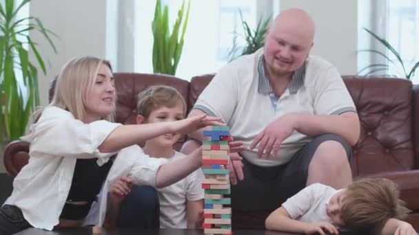 Famiglia di quattro persone che giocano nel gioco da tavolo, torre di legno — Video Stock