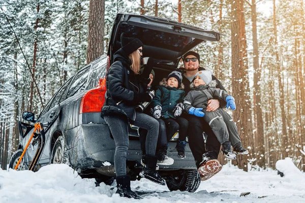 Famiglia caucasica vestita con abiti caldi nella foresta invernale — Foto Stock