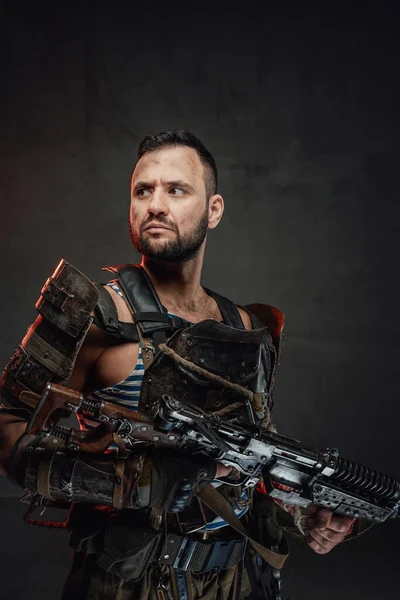 Apocalyptic survivor with shotgun in dark background