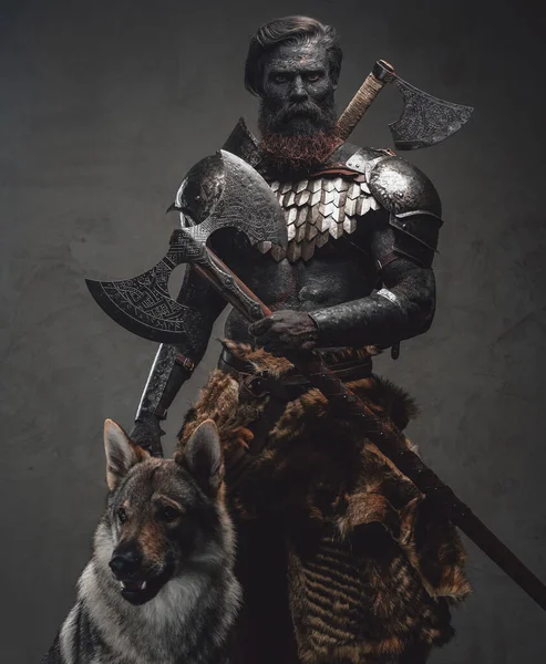 Demonic warrior with his wolf standing together in dark background — Stock Photo, Image