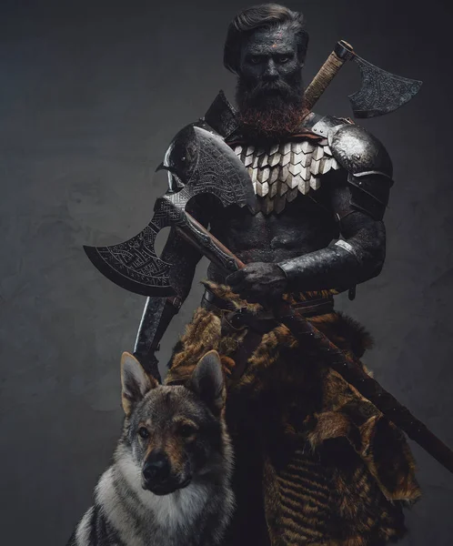 Mythical soldier with a wolf standing in dark background holding an axe — Stock Photo, Image