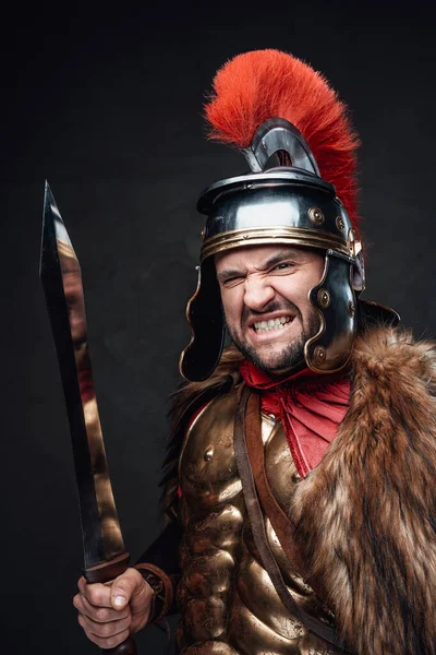Screaming roman soldier in golden armor and fur — Stock Photo, Image