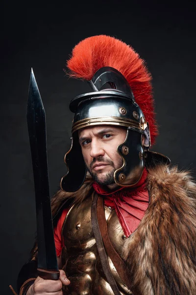 Imperial soldier with sword wearing fur against dark background — Stock Photo, Image