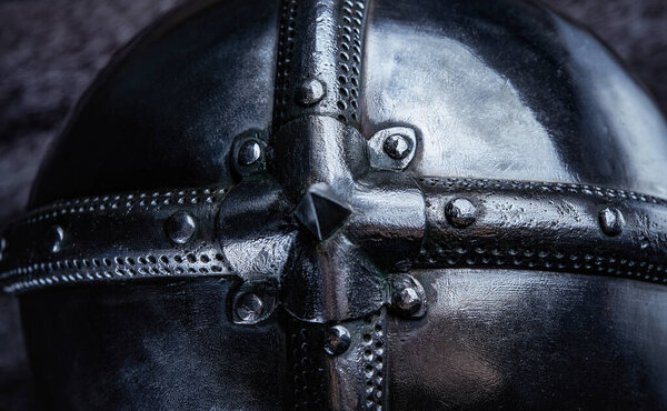 Top view sutdio shot of protective steel helmet of european knight on fur.