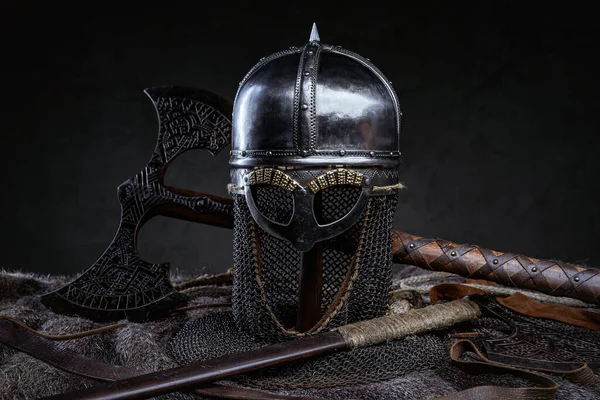 Iron antique helmet with fur and axe — Stock Photo, Image