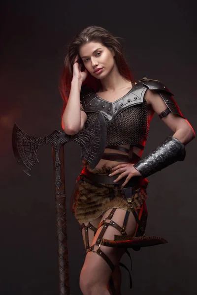 Studio shot of wild woman viking holding axe — Stock Photo, Image