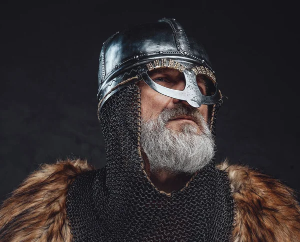 Serious elder templar with fur and steel helmet — Stock Photo, Image