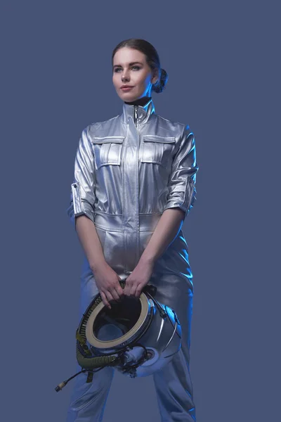 Female space explorer in spacesuit holding helmet — Stock Photo, Image