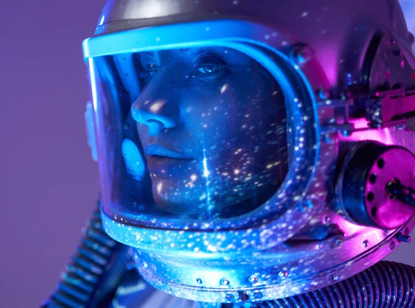 Female cosmonaut inside studio room with cosmic light — Stock Photo, Image