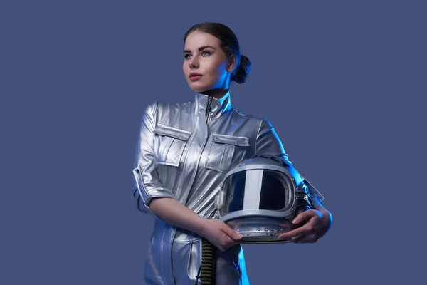 Female space explorer in spacesuit holding helmet — Stock Photo, Image