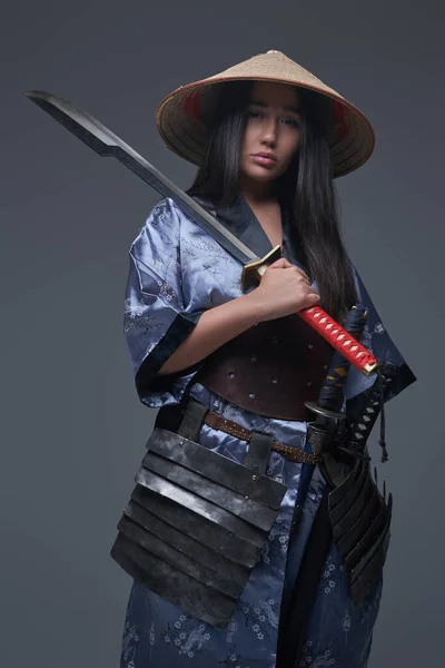 Female samurai holding katana on her shoulder — Stock Photo, Image