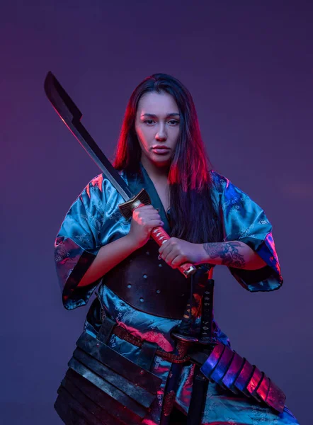 Žena východní asasín s mečem na barevném pozadí — Stock fotografie