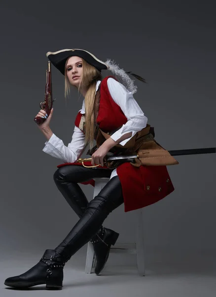 Attractive woman corsair with handgun and saber — Stock Photo, Image