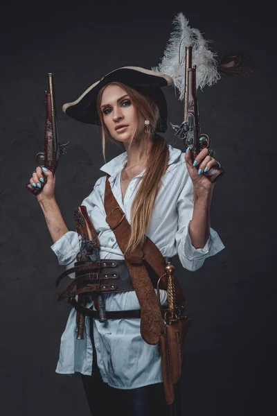 Woman corsair wearing shirt and hat with guns — Stock Photo, Image