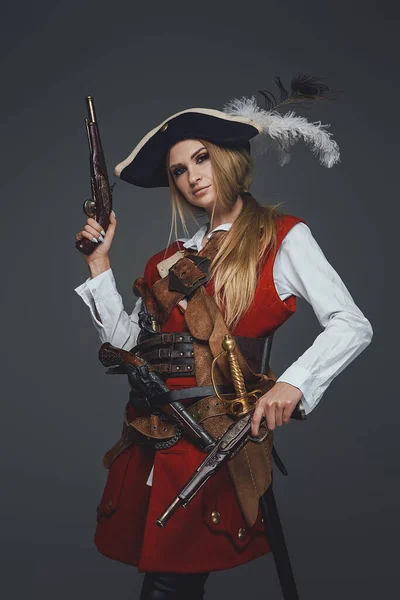 Side view studio shot of woman pirate with pistol — Stock Photo, Image