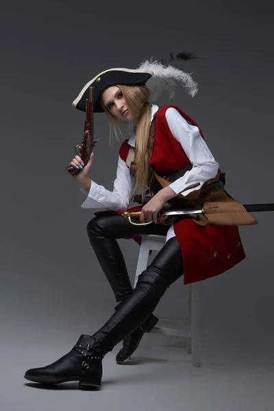 Attractive woman corsair with handgun and saber — Stock Photo, Image